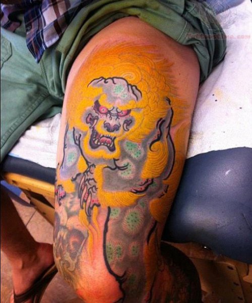 Yellow Ink Foo Dog Tattoo On Thigh